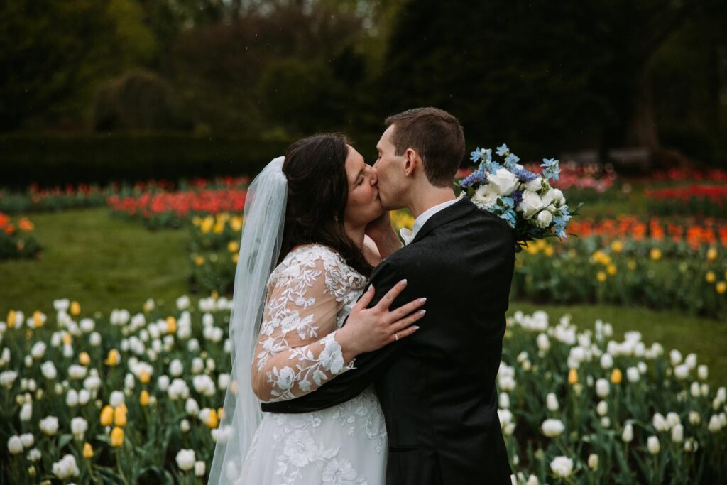 Bride and groom kissing at Elizabeth Park
