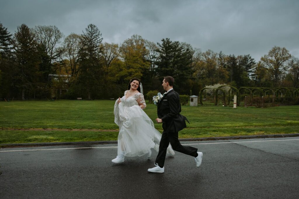 Couple running and laughing through Elizabeth Park tulip garden during spring wedding portraits