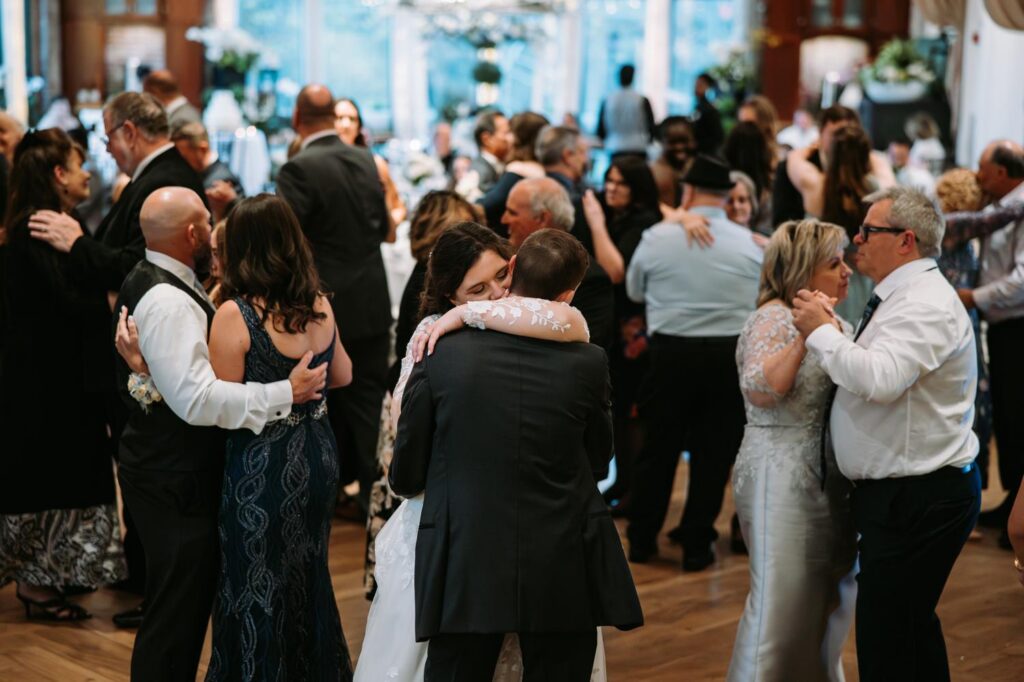 Full dance floor at Elizabeth Park wedding reception, guests dancing and celebrating