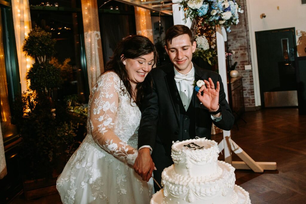 Bride and groom cutting wedding cake together, Pond House Cafe West Hartford wedding

