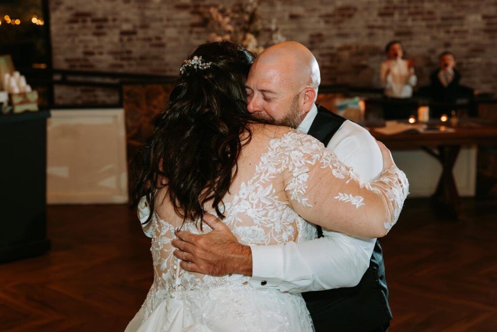 Bride and dad slow dancing in close embrace, Pond House Cafe wedding reception