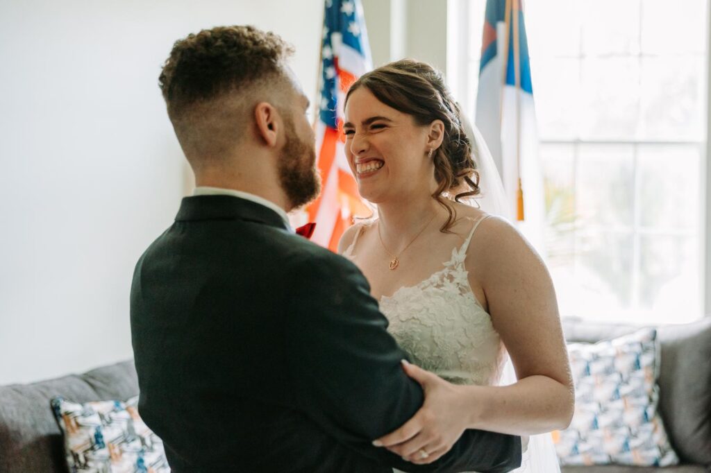 Close up of bride and groom laughing and holding each other right after getting married