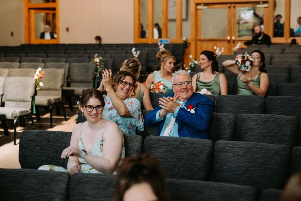Wedding guests reacting with delight and surprise watching Tim's piano performance after the ceremony, Bluebird Farm wedding