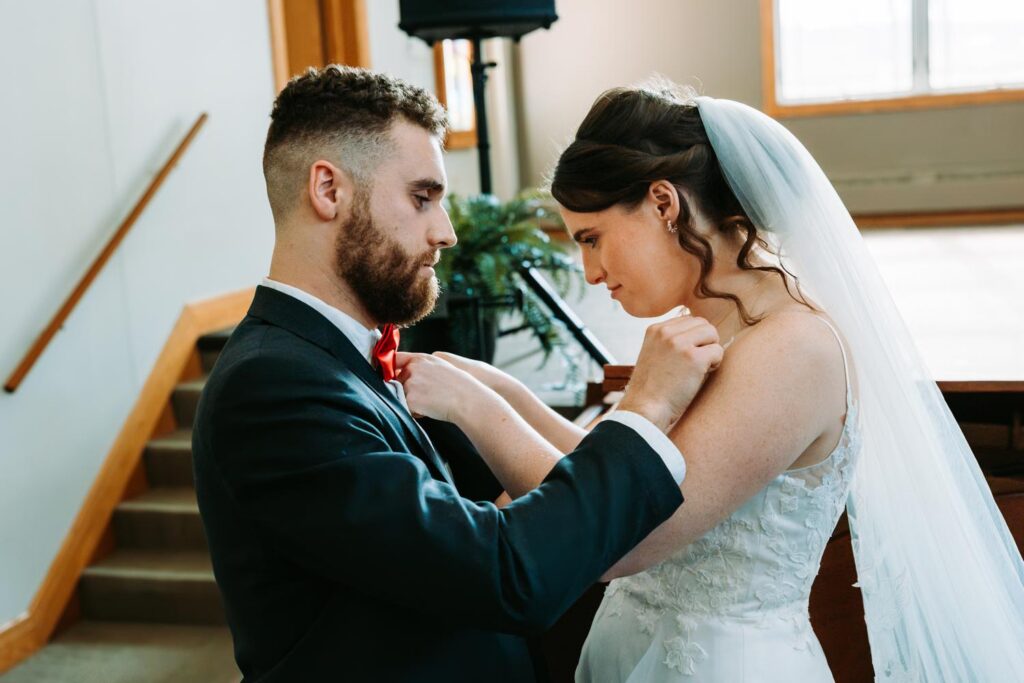 Groom showing bride the grape soda bottle cap from the movie Up, intimate close up moment after the piano performance
