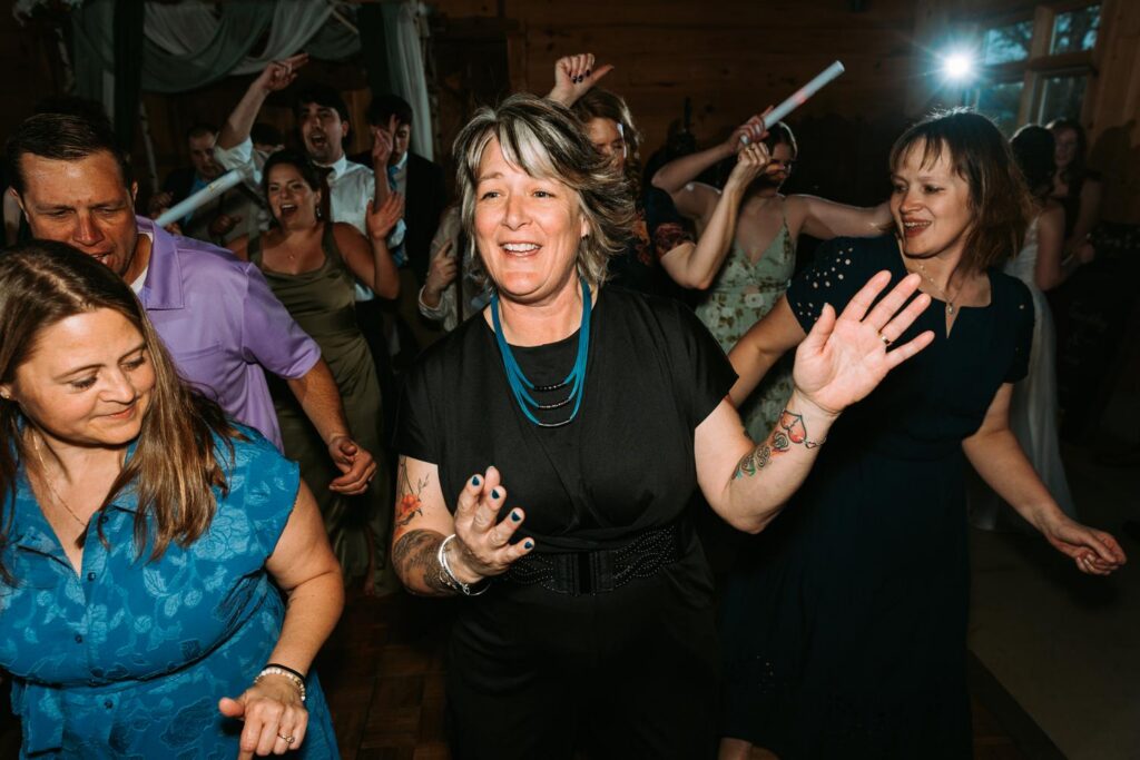 Older guest dancing enthusiastically and with complete abandon at the Bluebird Farm wedding reception