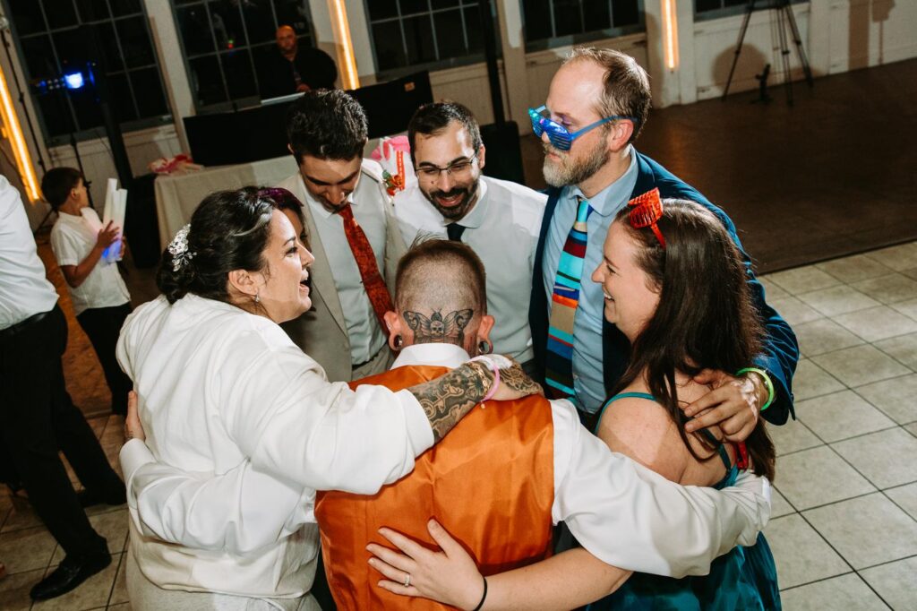 Guests dancing late into the night, warm lights and movement, Lighthouse Point Park reception